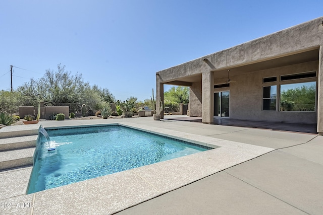 view of swimming pool featuring fence, ceiling fan, a fenced in pool, and a patio area