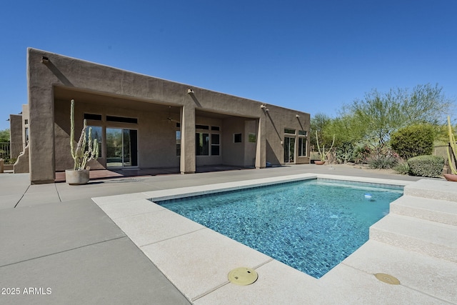 outdoor pool featuring a patio and ceiling fan