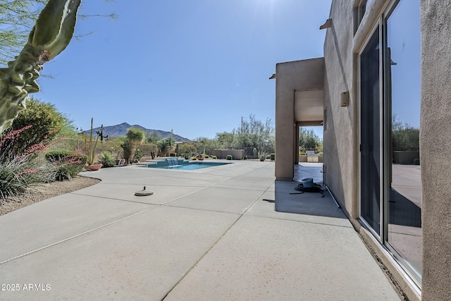 view of patio / terrace with a fenced in pool, a mountain view, and a fenced backyard