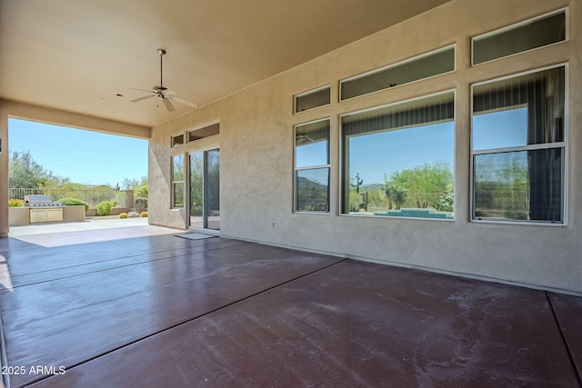 view of patio featuring exterior kitchen and ceiling fan