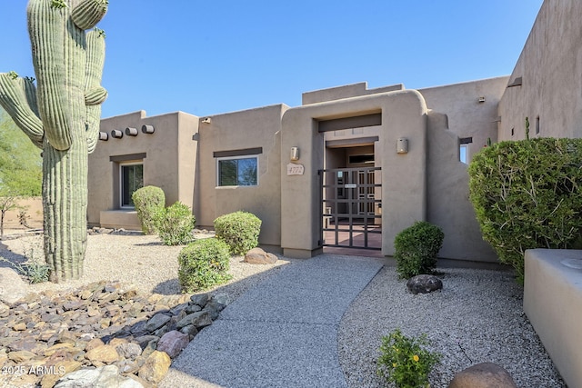 entrance to property featuring stucco siding
