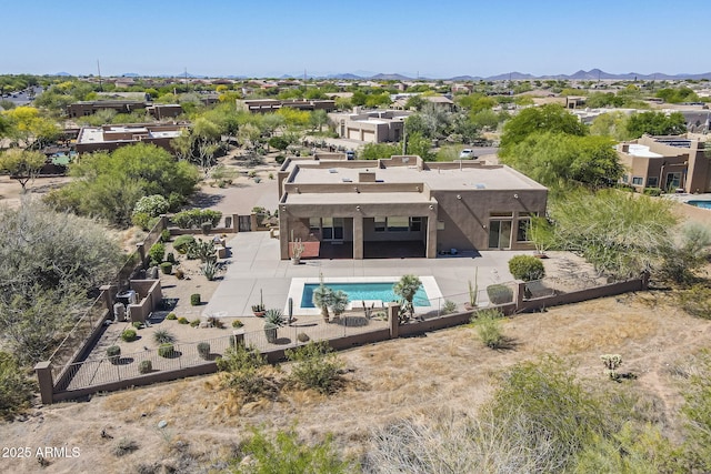 outdoor pool featuring a fenced backyard, a patio area, and a mountain view