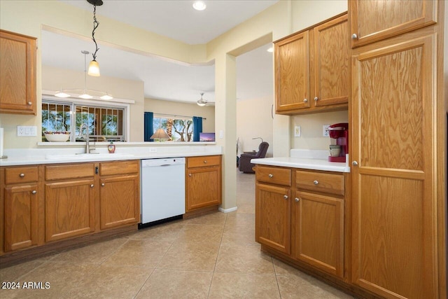 kitchen featuring hanging light fixtures, dishwasher, light tile patterned floors, and sink