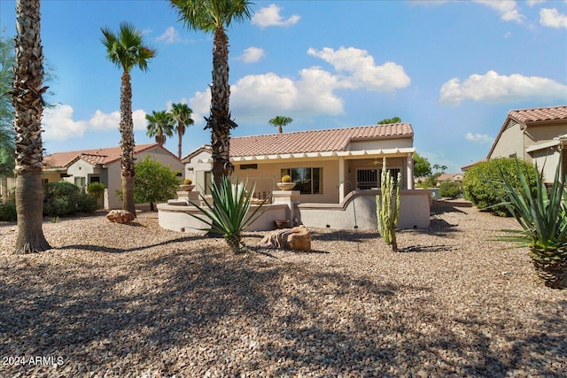 back of property with a patio