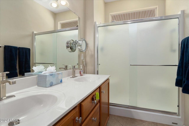 bathroom featuring walk in shower, tile patterned flooring, and vanity