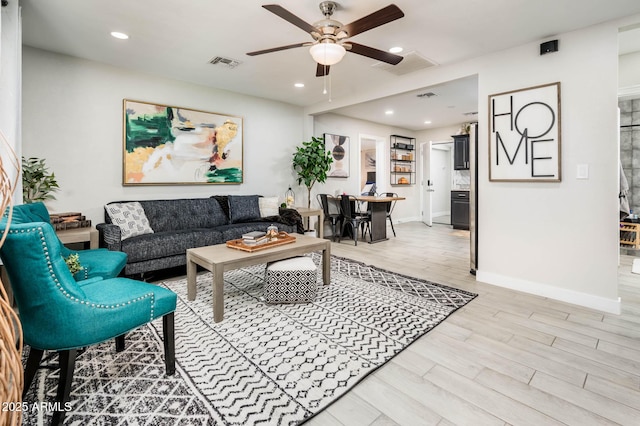 living room with ceiling fan and light wood-type flooring