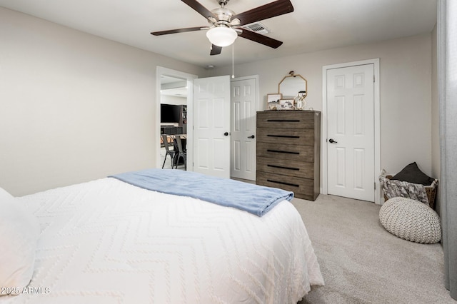 bedroom featuring light colored carpet and ceiling fan