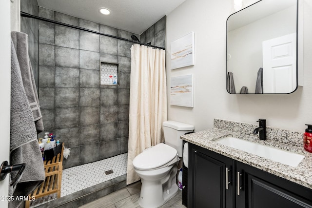 bathroom featuring vanity, a shower with curtain, and toilet