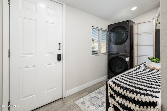 bedroom featuring stacked washer / drying machine and light wood-type flooring