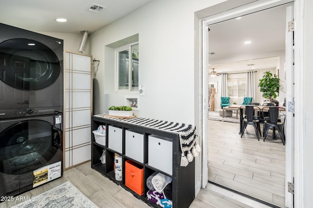 clothes washing area featuring stacked washer / drying machine