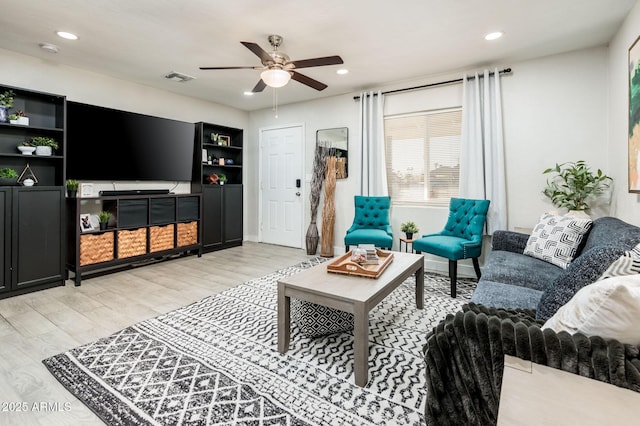 living room featuring ceiling fan and light wood-type flooring