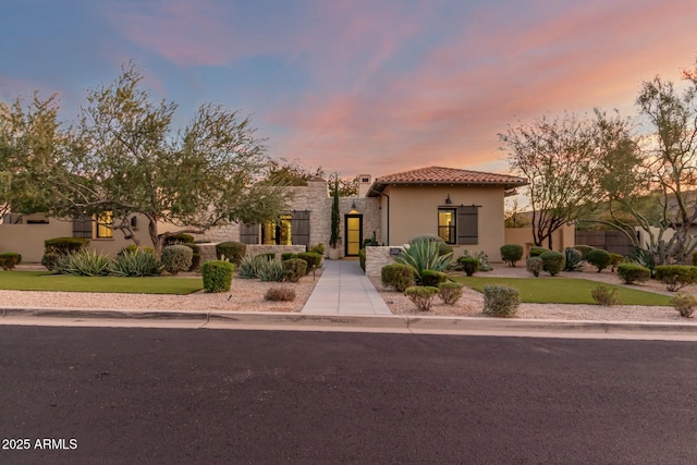 mediterranean / spanish home featuring a yard