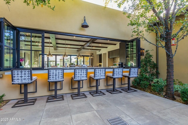 view of patio with exterior bar