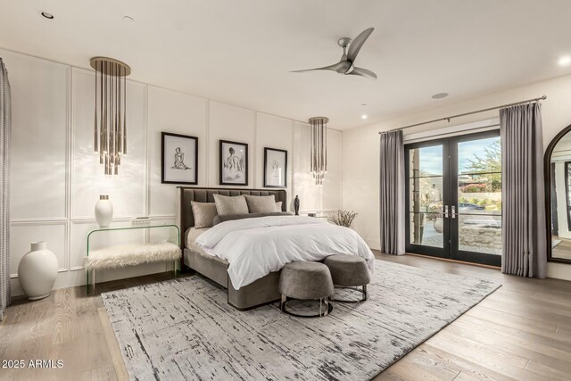 bedroom featuring access to outside, french doors, ceiling fan, and light wood-type flooring