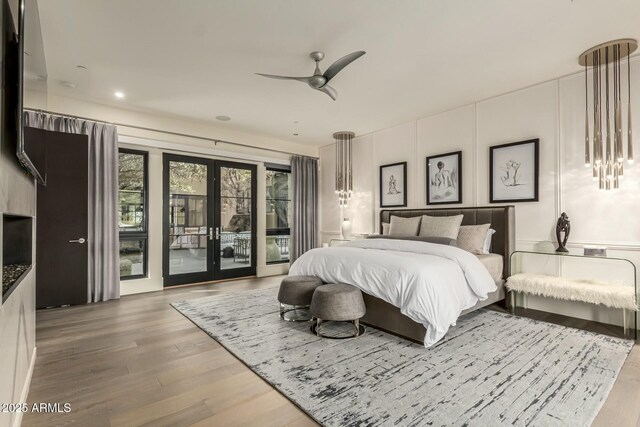 bedroom featuring hardwood / wood-style floors, access to outside, ceiling fan, and french doors