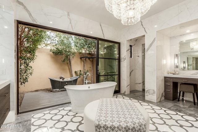 bathroom with independent shower and bath, vanity, tile walls, and a notable chandelier