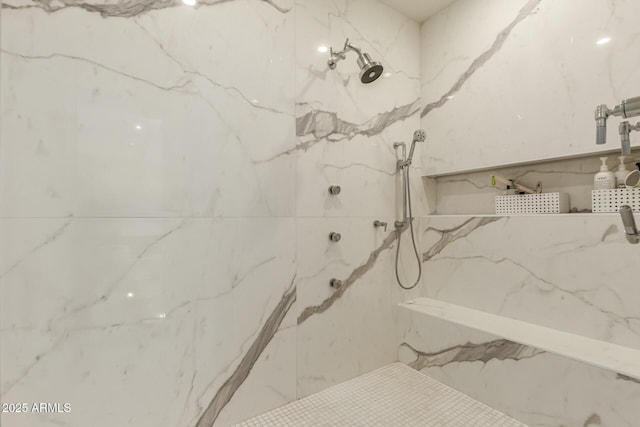 bathroom with a tile shower