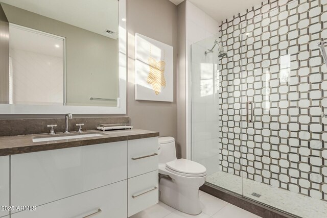 bathroom featuring walk in shower, vanity, toilet, and tile patterned flooring