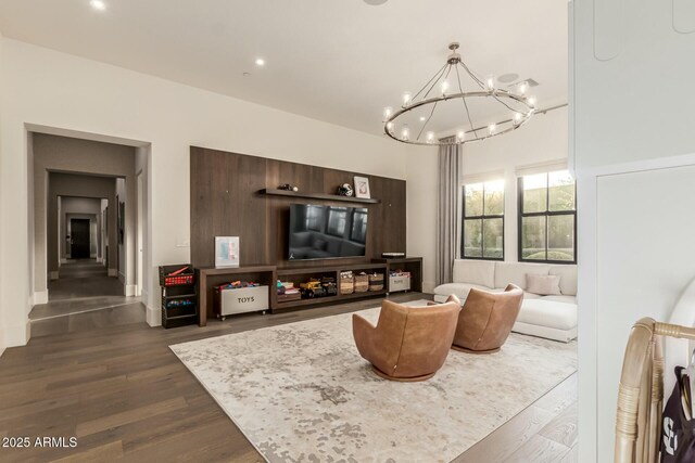 living room with an inviting chandelier and dark hardwood / wood-style flooring