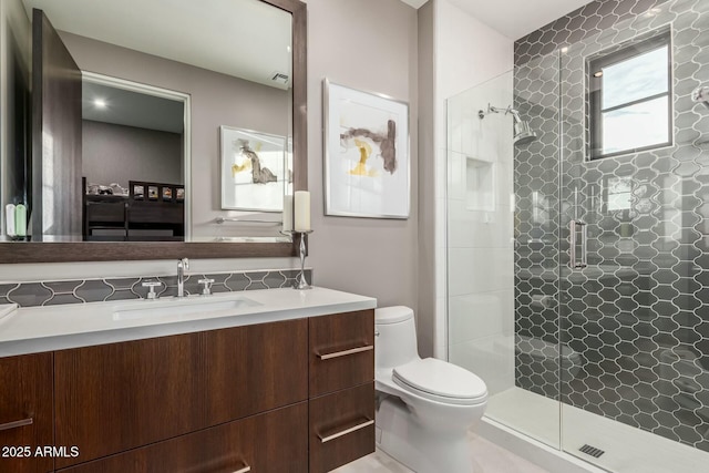 bathroom featuring vanity, toilet, and walk in shower