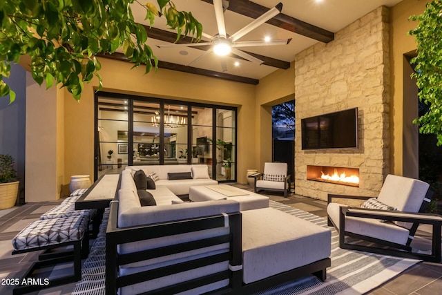 view of patio featuring ceiling fan and an outdoor living space with a fireplace