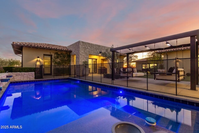 pool at dusk with a patio