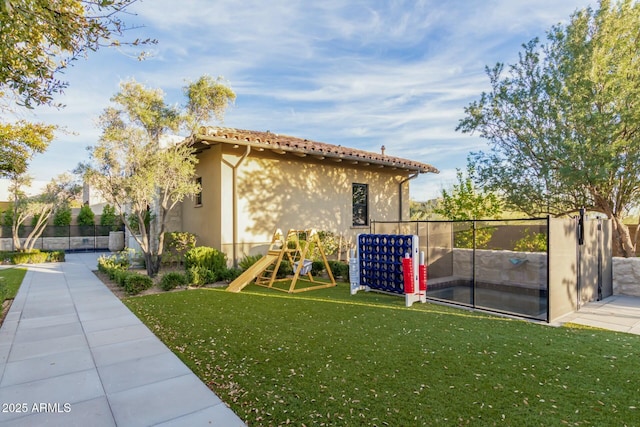 exterior space with a yard and a playground