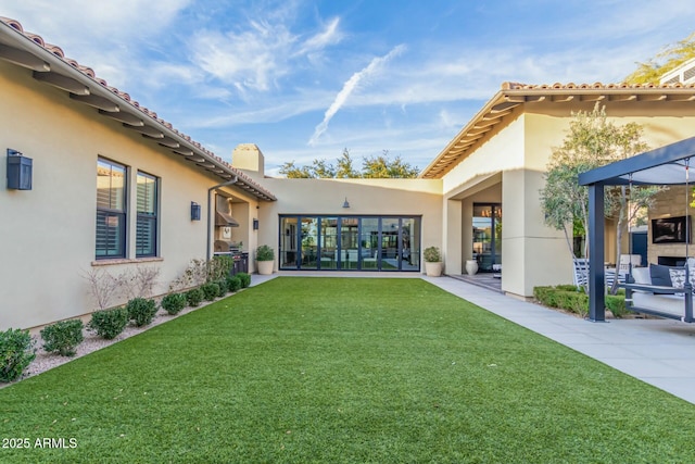 rear view of house featuring a lawn