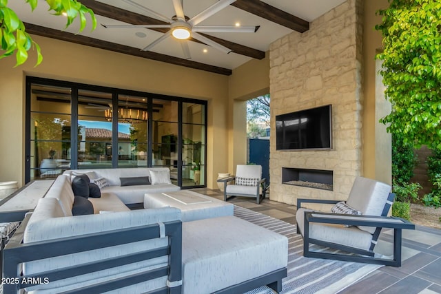 view of patio with an outdoor living space with a fireplace and ceiling fan