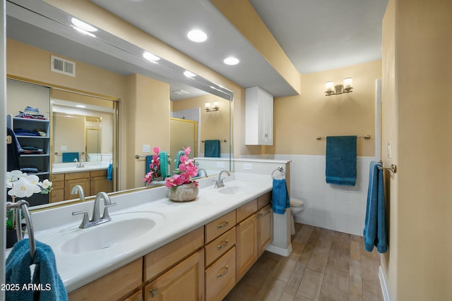 5830 E Mckellips Rd Unit 2, Mesa, AZ 85215 - full bath with toilet, double vanity, tile walls, wainscoting, and wood finished floors