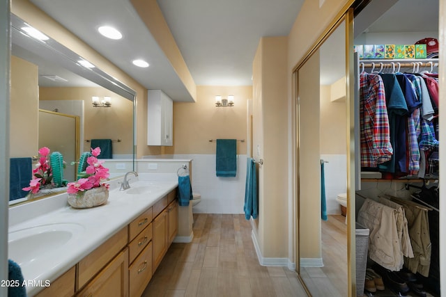 5830 E Mckellips Rd Unit 2, Mesa, AZ 85215 - full bathroom with toilet, tile walls, wainscoting, double vanity, and a shower stall