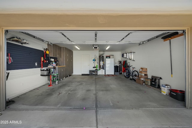 5830 E Mckellips Rd Unit 2, Mesa, AZ 85215 - garage featuring freestanding refrigerator, water heater, and a garage door opener