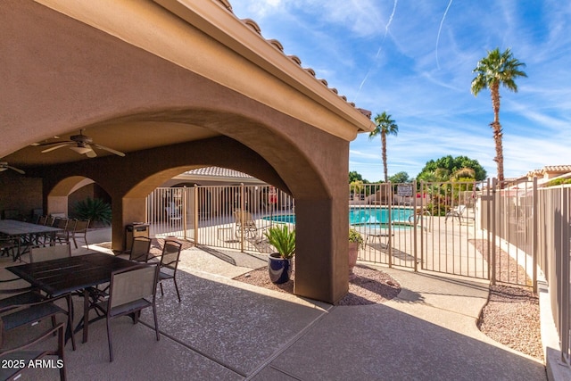 5830 E Mckellips Rd Unit 2, Mesa, AZ 85215 - view of patio with a community pool, outdoor dining space, and a ceiling fan