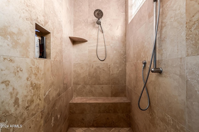 bathroom featuring tiled shower