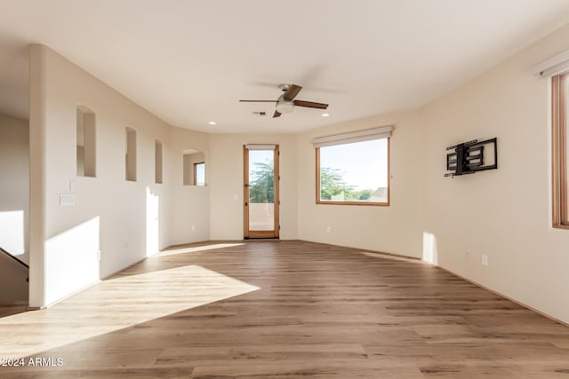 spare room with light hardwood / wood-style floors and ceiling fan