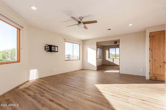 spare room featuring light hardwood / wood-style floors, plenty of natural light, and ceiling fan