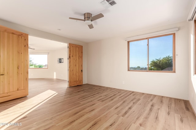 unfurnished room with ceiling fan and light hardwood / wood-style flooring