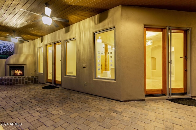 exterior space with ceiling fan and wood ceiling