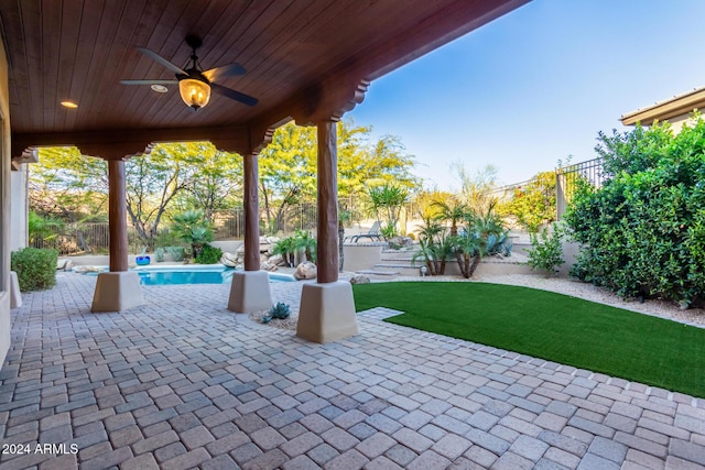 view of patio / terrace with a fenced in pool and ceiling fan