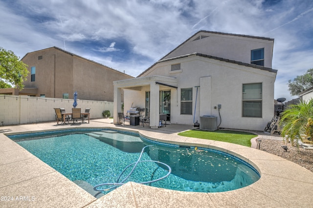 view of pool with a patio area and central air condition unit