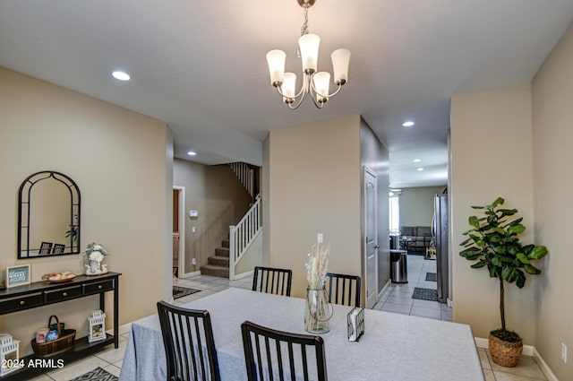 dining space with recessed lighting, a notable chandelier, light tile patterned flooring, and stairs