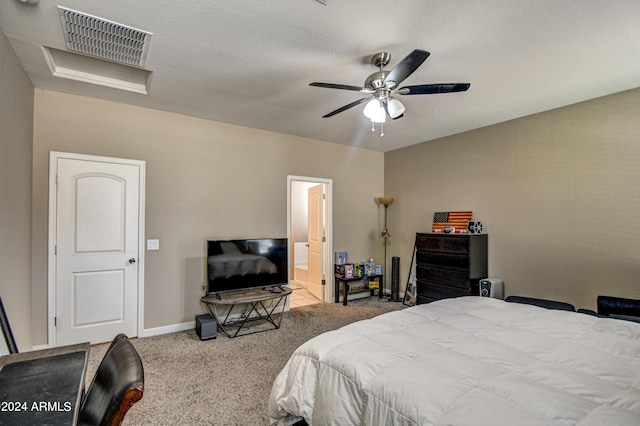 bedroom with visible vents, baseboards, ceiling fan, carpet, and attic access