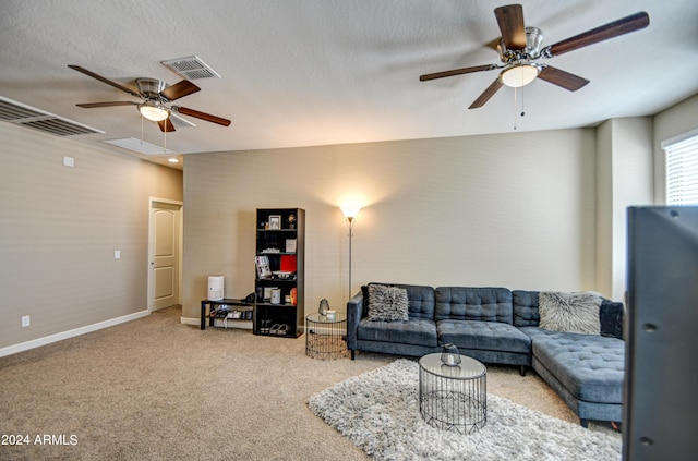 carpeted living room with visible vents, a textured ceiling, and ceiling fan