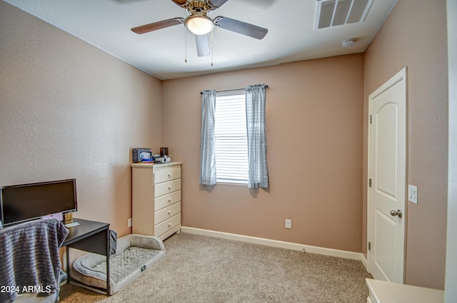 carpeted office featuring visible vents, baseboards, and ceiling fan