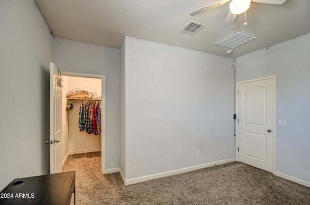 empty room with baseboards, carpet, visible vents, and ceiling fan