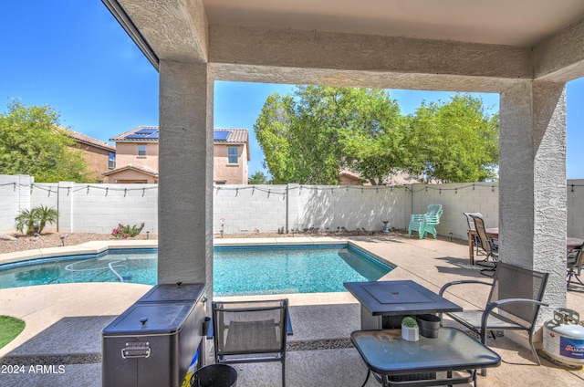 view of swimming pool featuring a fenced in pool, a fenced backyard, and a patio area