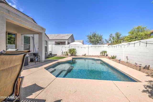 view of swimming pool featuring a fenced in pool, a patio, and a fenced backyard