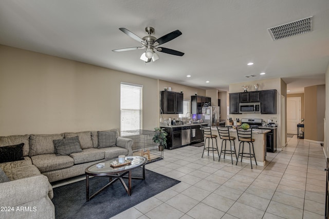 living area with light tile patterned floors, visible vents, ceiling fan, and recessed lighting