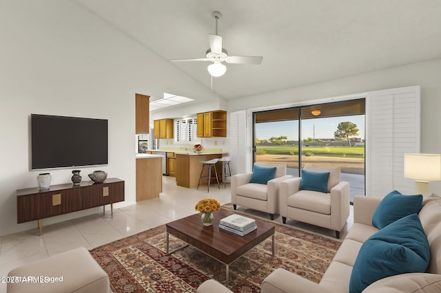 living room featuring light tile patterned floors, ceiling fan, and high vaulted ceiling