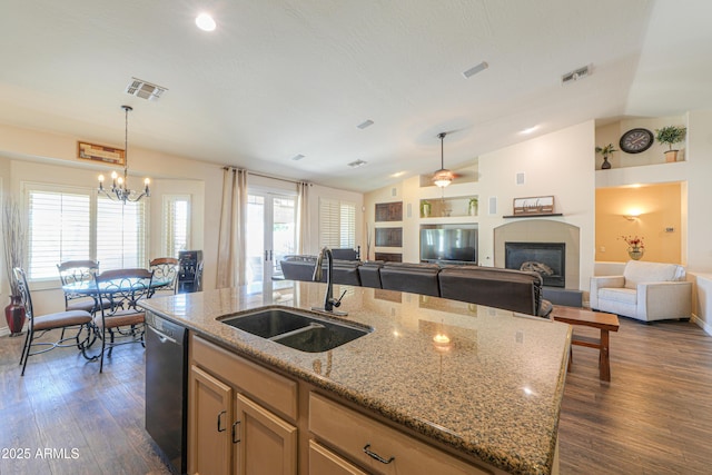 2041 E Palm Beach Dr, Chandler, AZ 85249 - kitchen with dishwashing machine, a chandelier, lofted ceiling, a glass covered fireplace, and open floor plan